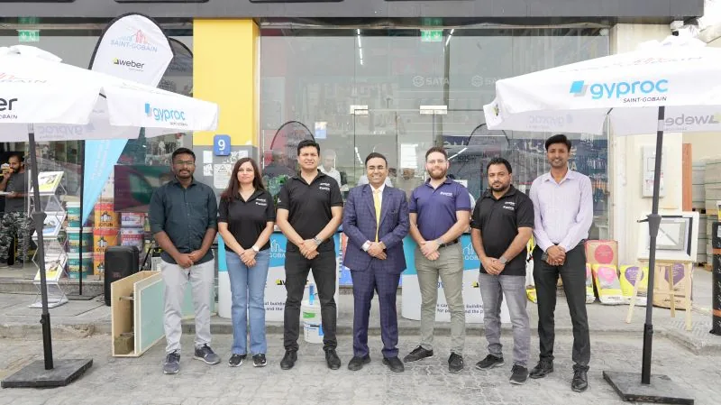 Al Zaabi Group and Saint-Gobain teams beside Weber and Gyproc product displays
